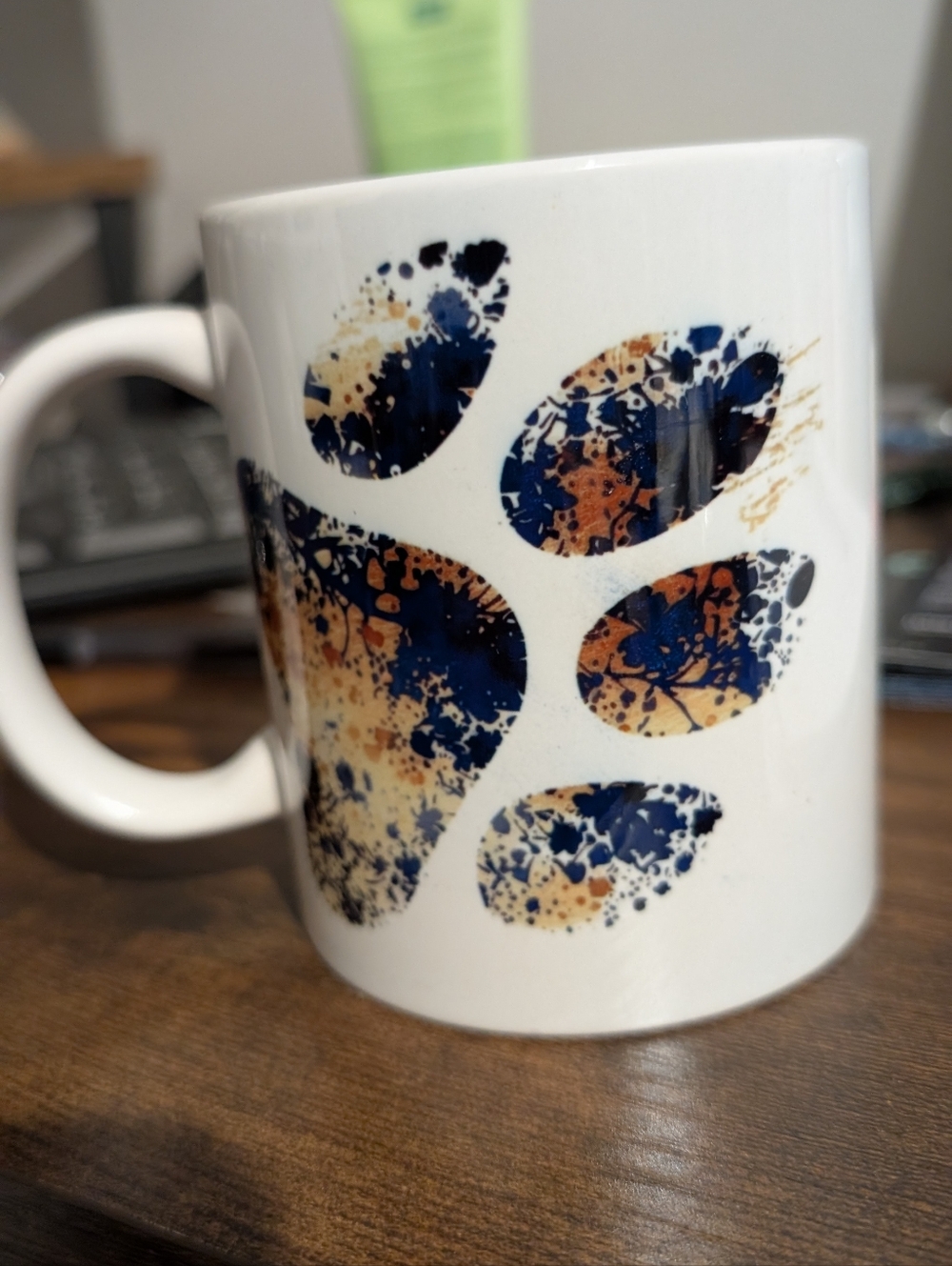 White Ceramic Mug with Blue and Orange Paw Print Design - Handcrafted